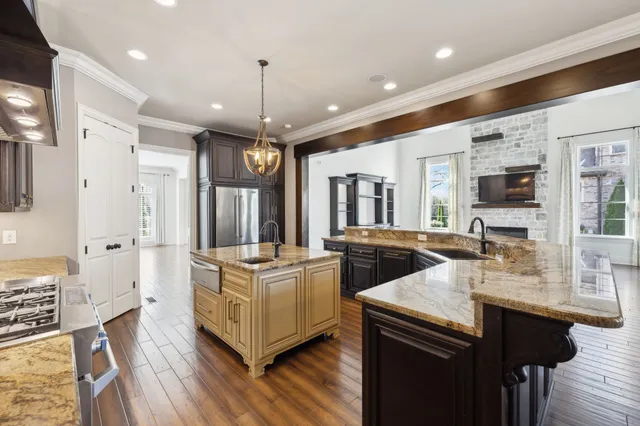 a view of a kitchen with cabinets and wooden floor