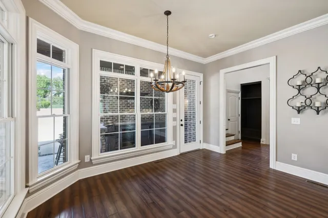 a view of a livingroom with a ceiling fan and window