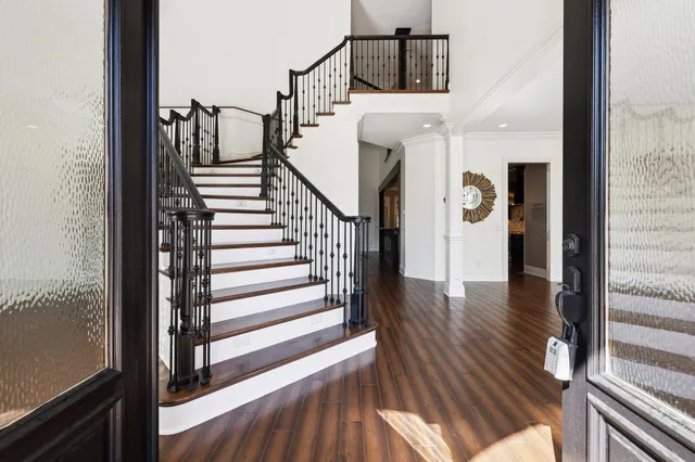 a view of entryway and hall with wooden floor