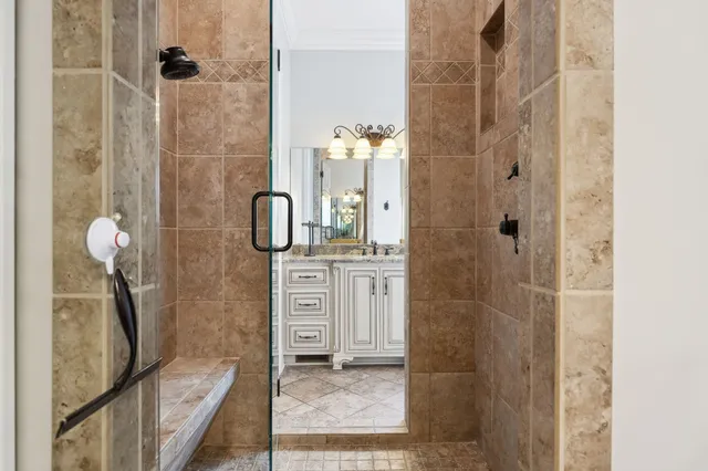 a bathroom with a granite countertop sink a mirror and a bathtub