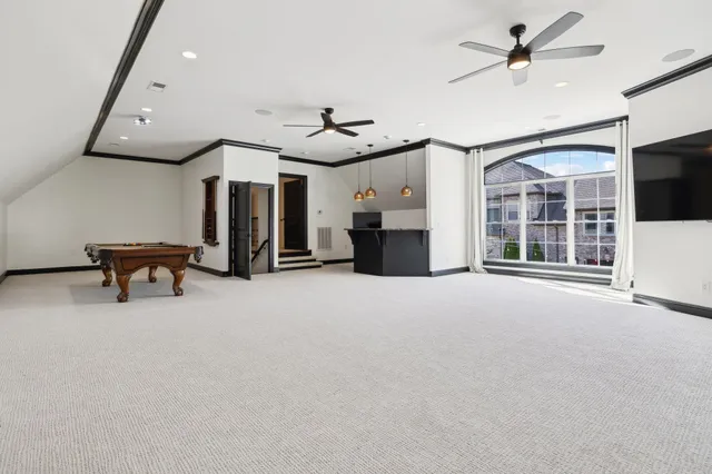 a kitchen with a sink a stove and chairs