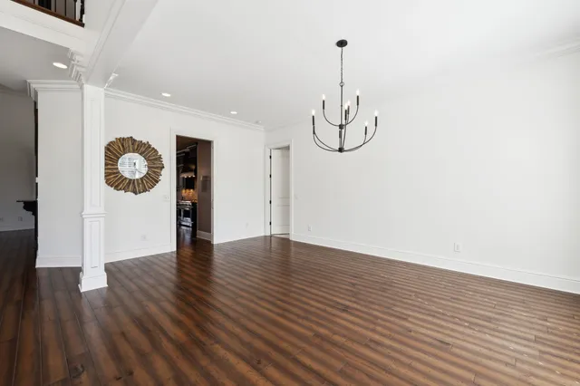 a view of a room with wooden floor and white walls