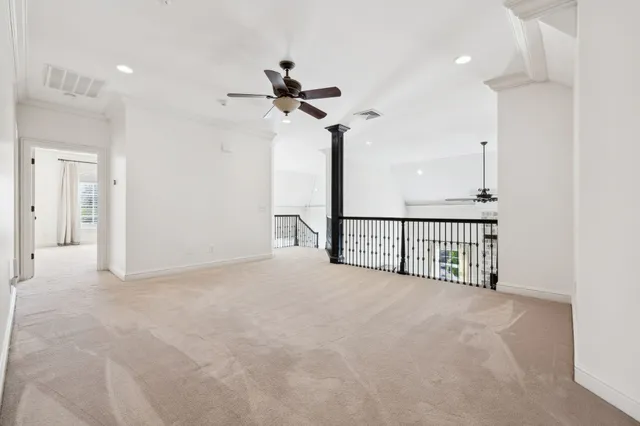 an empty room with closet and a ceiling fan