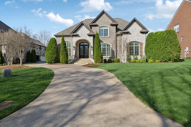 a front view of house with yard and green space