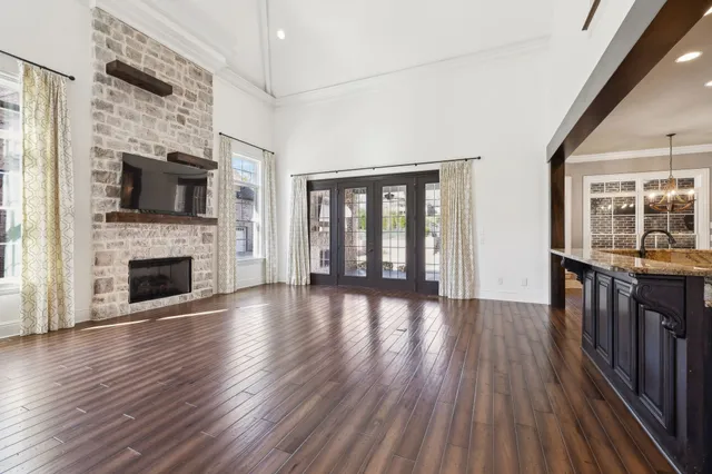 a view of a living room with hardwood floor and a fireplace