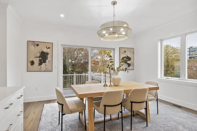 a view of a dining room with furniture wooden floor and a chandelier