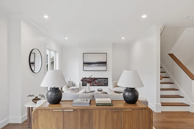 a living room with furniture a window and a lamp