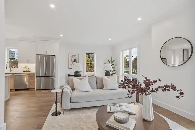 a living room with furniture and a kitchen