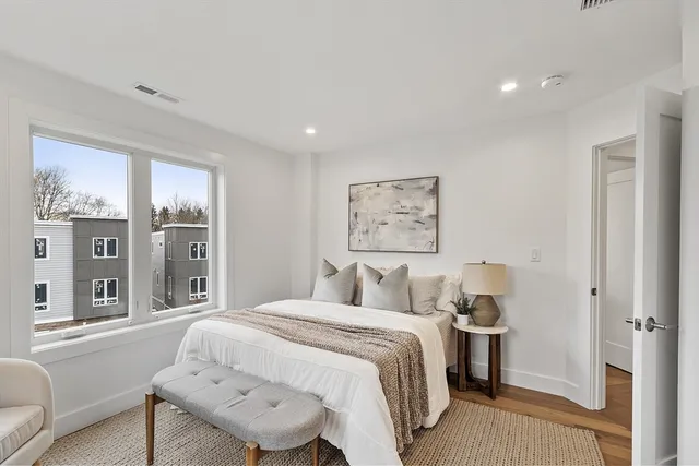 a bedroom with a bed and glass window