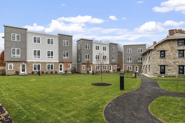 a view of a big building with a big yard and plants