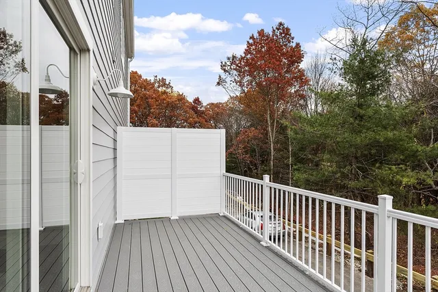 a view of a balcony with wooden floor and fence