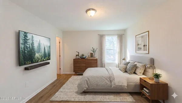 a bedroom with a large bed and a chandelier
