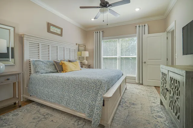 a bedroom with a bed and ceiling fan