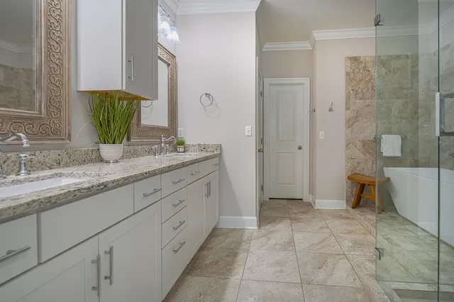 a bathroom with a granite countertop sink a toilet and a shower