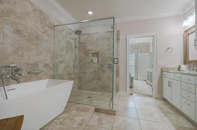 a bathroom with a granite countertop sink a toilet and shower