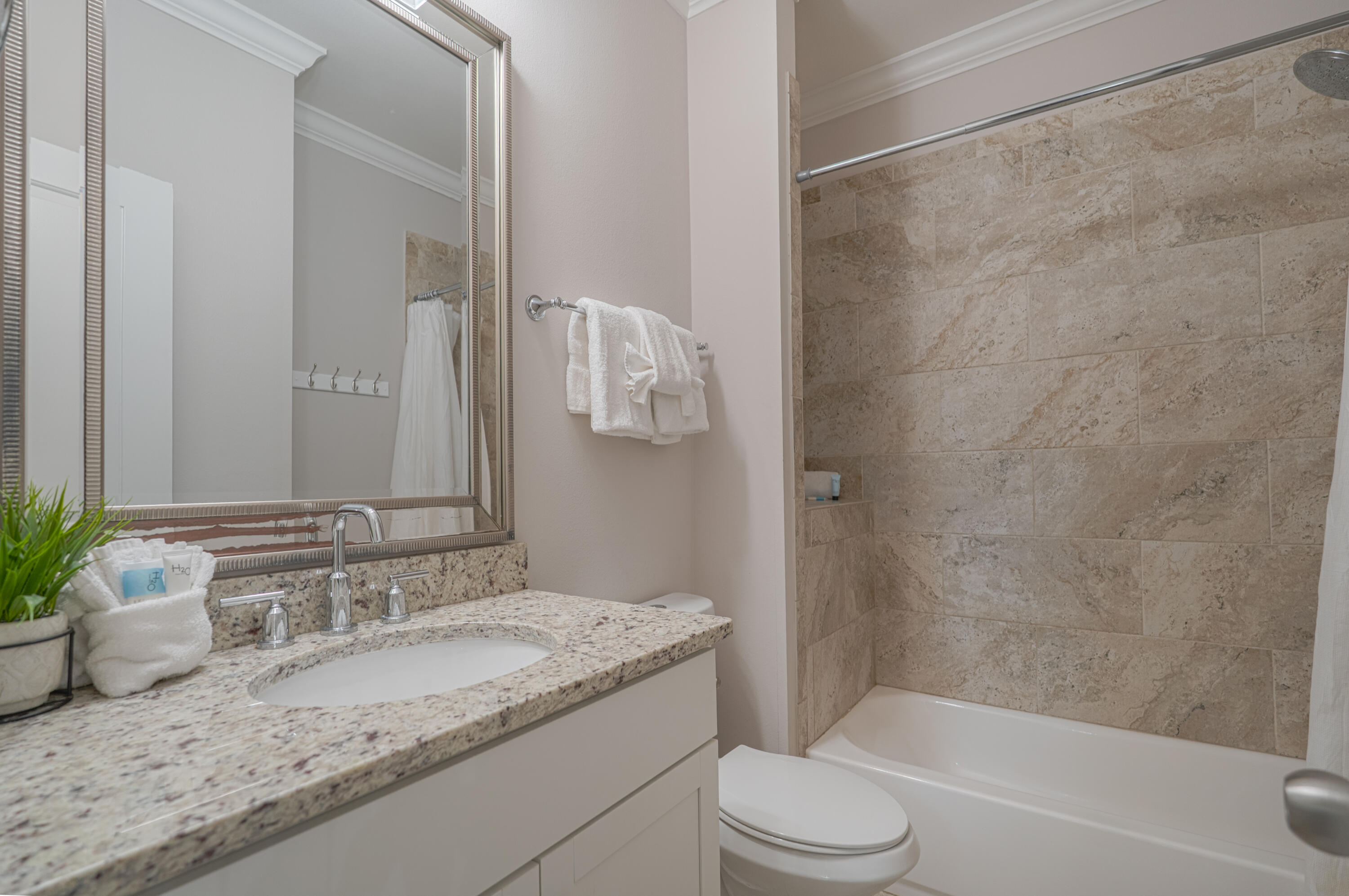 257 Driftwood Road, Unit 1 Miramar Beach, FL 32550 - Photo 20 of 36 a bathroom with a granite countertop sink and a mirror