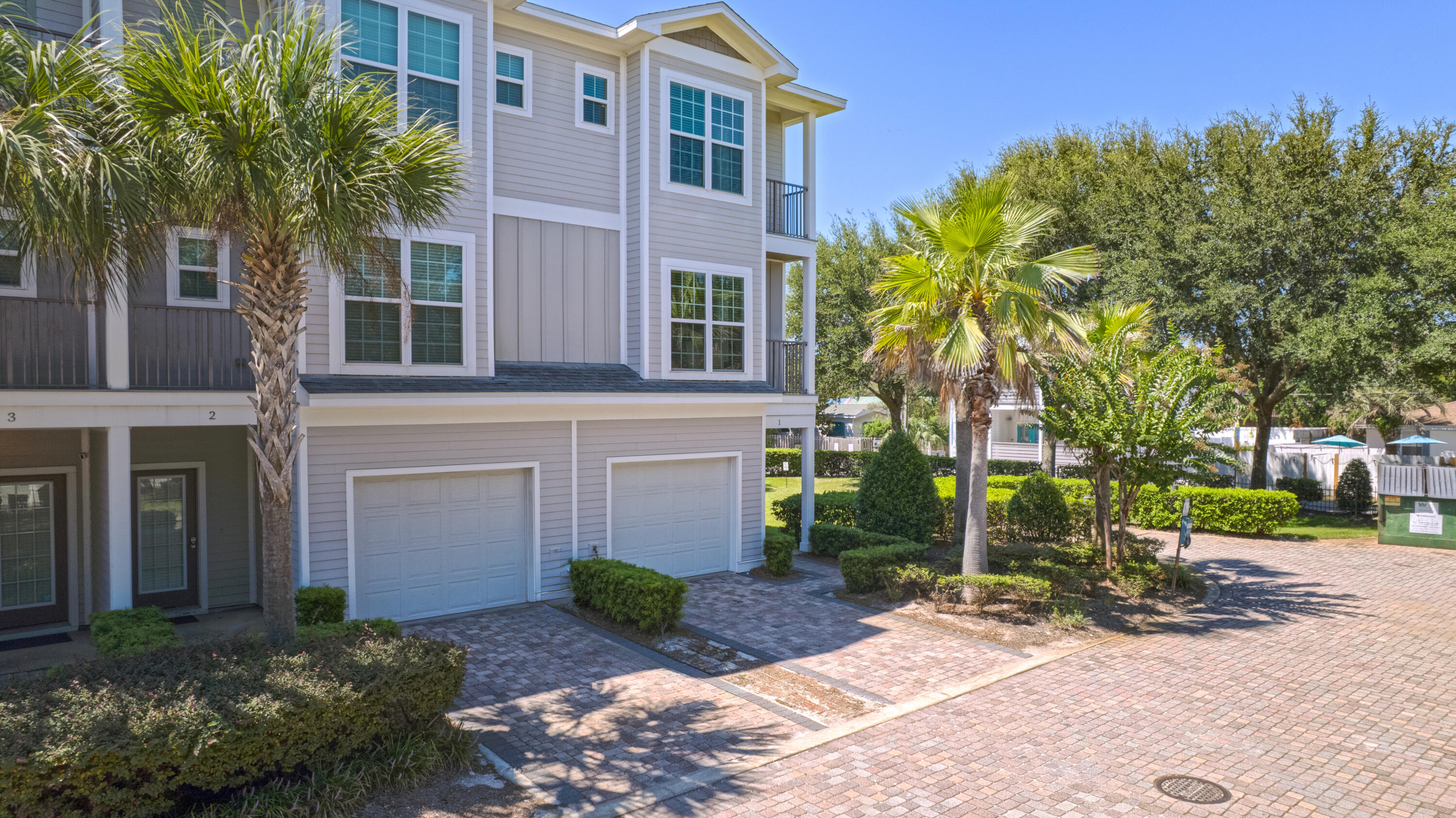 257 Driftwood Road, Unit 1 Miramar Beach, FL 32550 - Photo 2 of 36 a front view of a house with a yard and trees