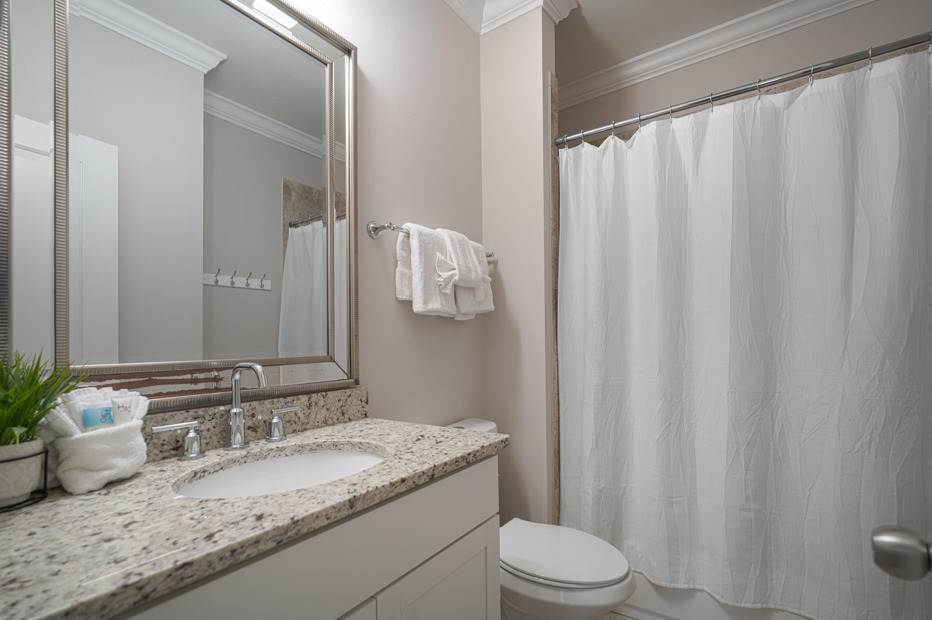 257 Driftwood Road, Unit 1 Miramar Beach, FL 32550 - Photo 21 of 36 a bathroom with a granite countertop sink and a mirror