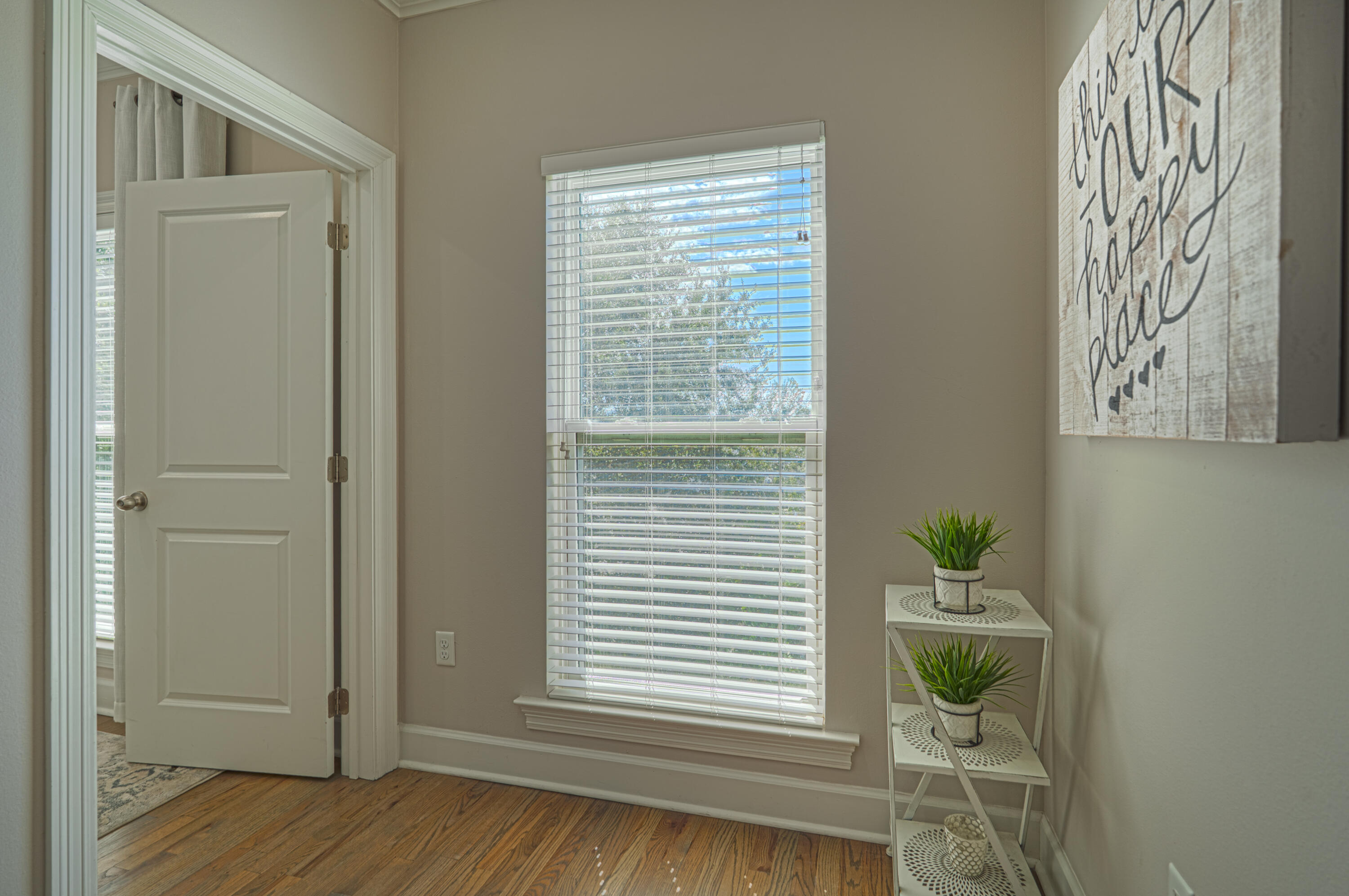 257 Driftwood Road, Unit 1 Miramar Beach, FL 32550 - Photo 23 of 36 a view of a bedroom with a window and wooden floor