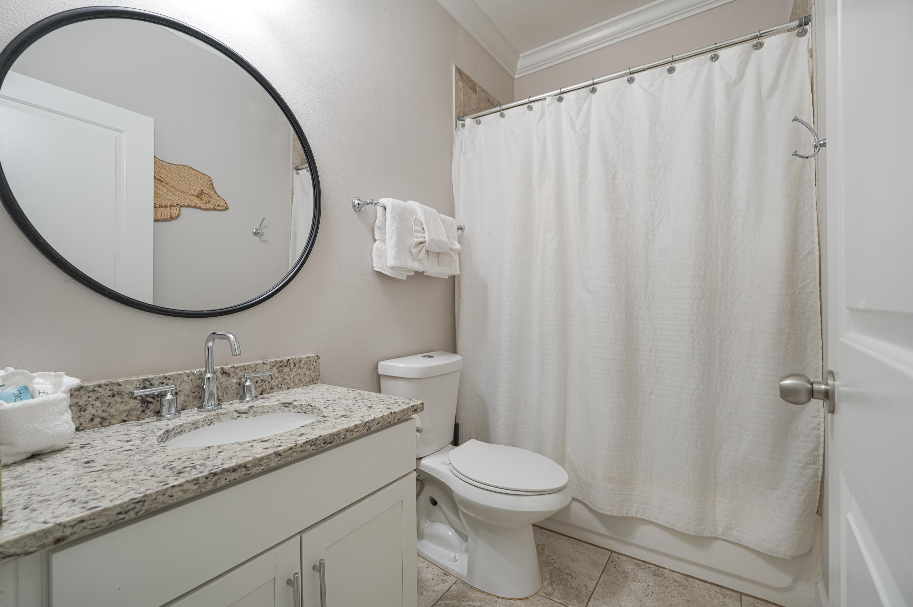 257 Driftwood Road, Unit 1 Miramar Beach, FL 32550 - Photo 30 of 36 a bathroom with a granite countertop sink and a mirror
