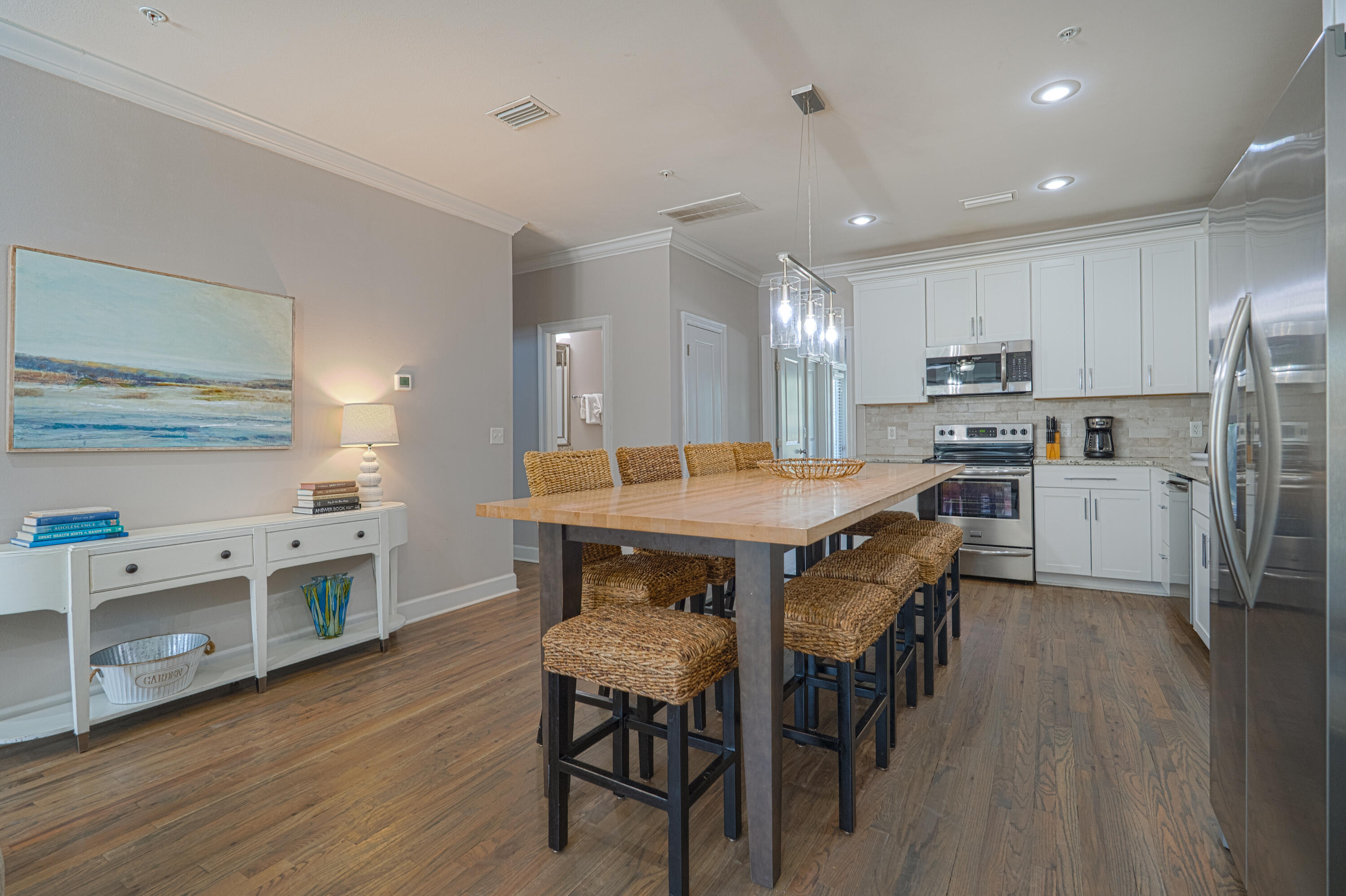 257 Driftwood Road, Unit 1 Miramar Beach, FL 32550 - Photo 8 of 36 a kitchen with stainless steel appliances a table chairs refrigerator and a sink