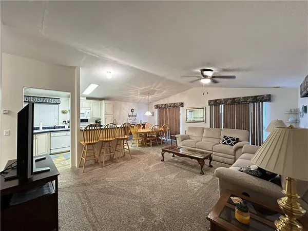 a living room with furniture and a kitchen
