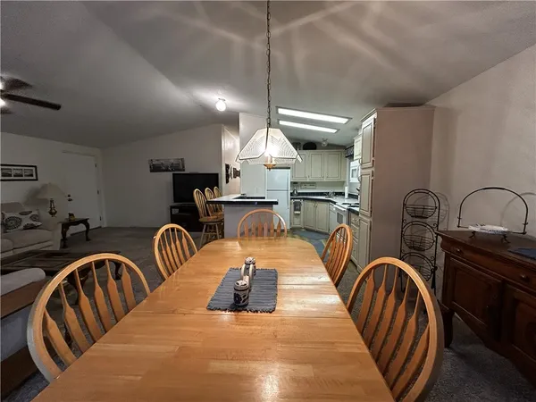 a kitchen with stainless steel appliances granite countertop a sink a stove and a wooden floors
