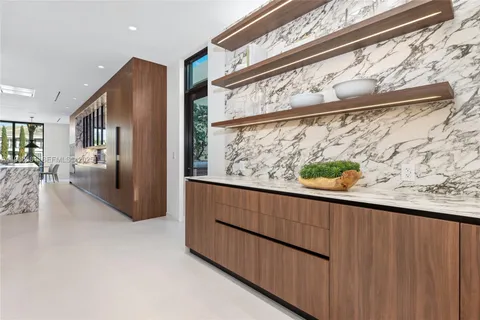 a dining room with furniture a chandelier and fireplace