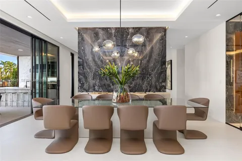 a living room with patio furniture and a potted plant