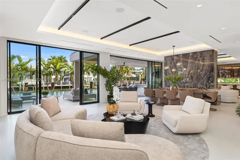 a living room with large windows and furniture