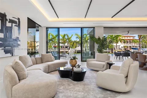 a living room with furniture and large windows