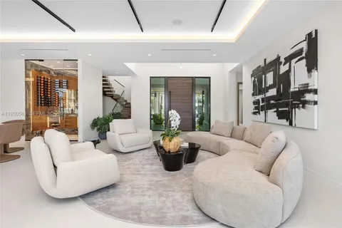 a living room with furniture and a floor to ceiling window