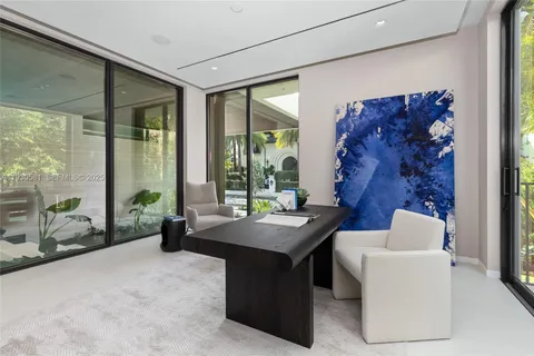 a living room with furniture and large windows