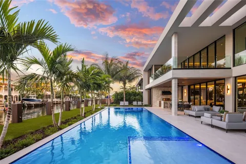 a view of a swimming pool with outdoor seating