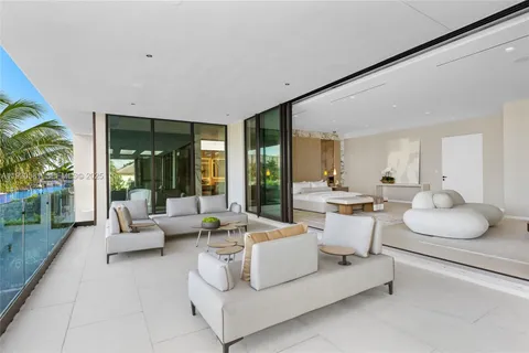 a bedroom with a bed couch and painting on the wall