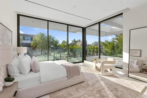 a dining room with furniture and a floor to ceiling window