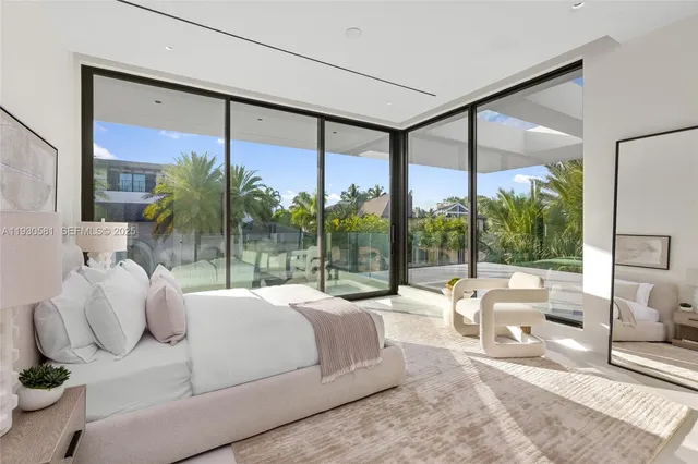a dining room with furniture and a floor to ceiling window