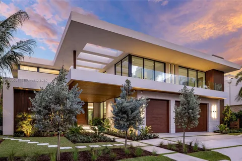 a large living room with stainless steel appliances kitchen island granite countertop a couch and a large window