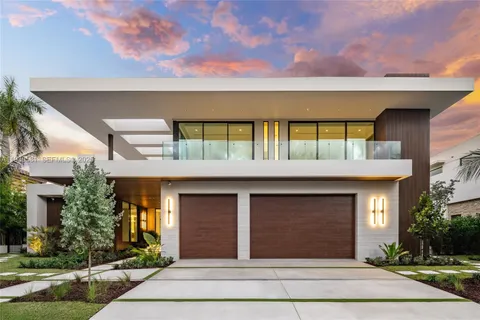 a kitchen with a sink and chairs