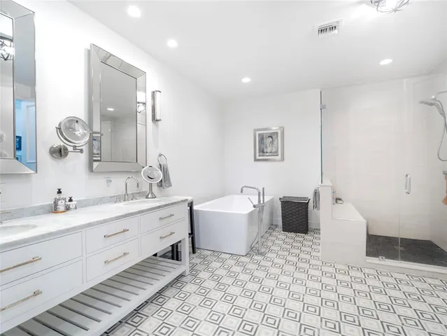 a bathroom with a tub sink and mirror