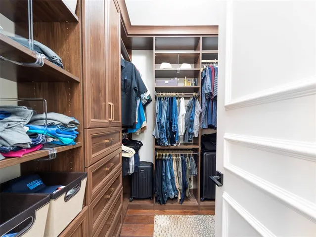 a spacious bedroom with a bed a couch and a window