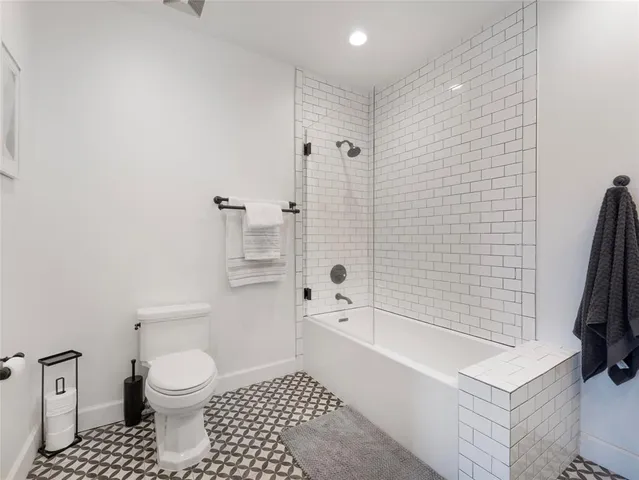 a spacious bedroom with a bed and a couch