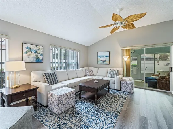 a spacious bedroom with a bed a couch and a window