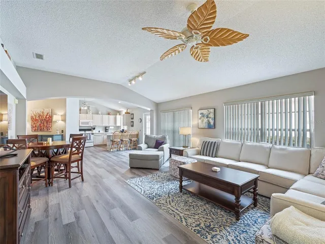 a living room with furniture wooden floor and dining table