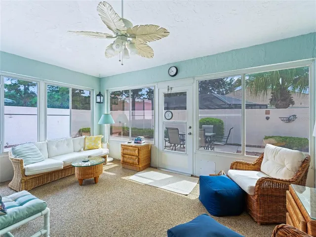 a living room with furniture and a large window with garden view