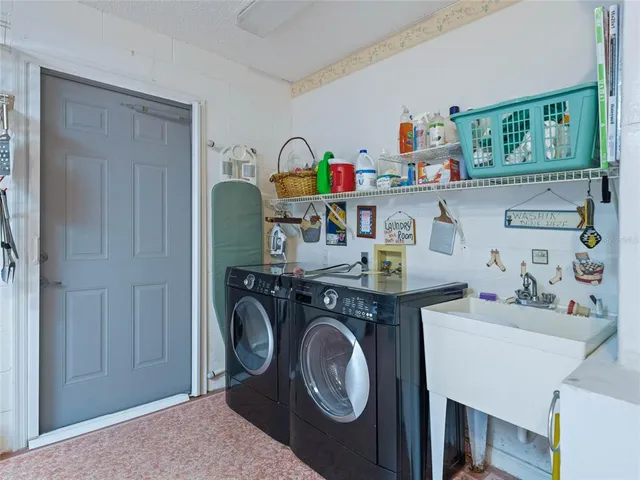 a utility room with dryer washer and a sink