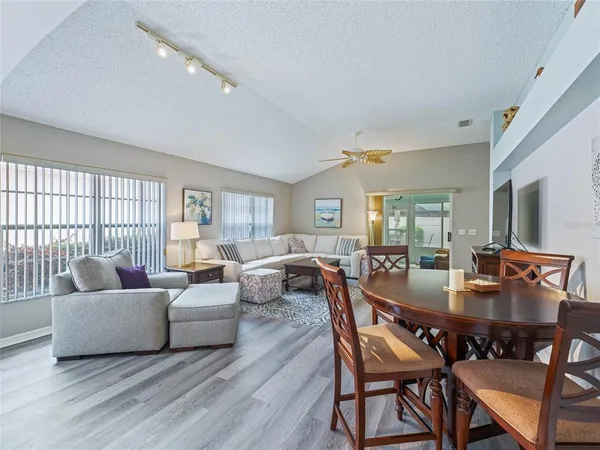 a living room with fireplace furniture and a table