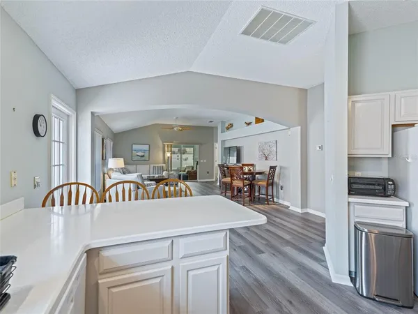 a view of a dining room with furniture wooden floor and a chandelier