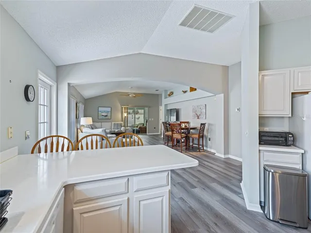 a view of a dining room with furniture wooden floor and a chandelier