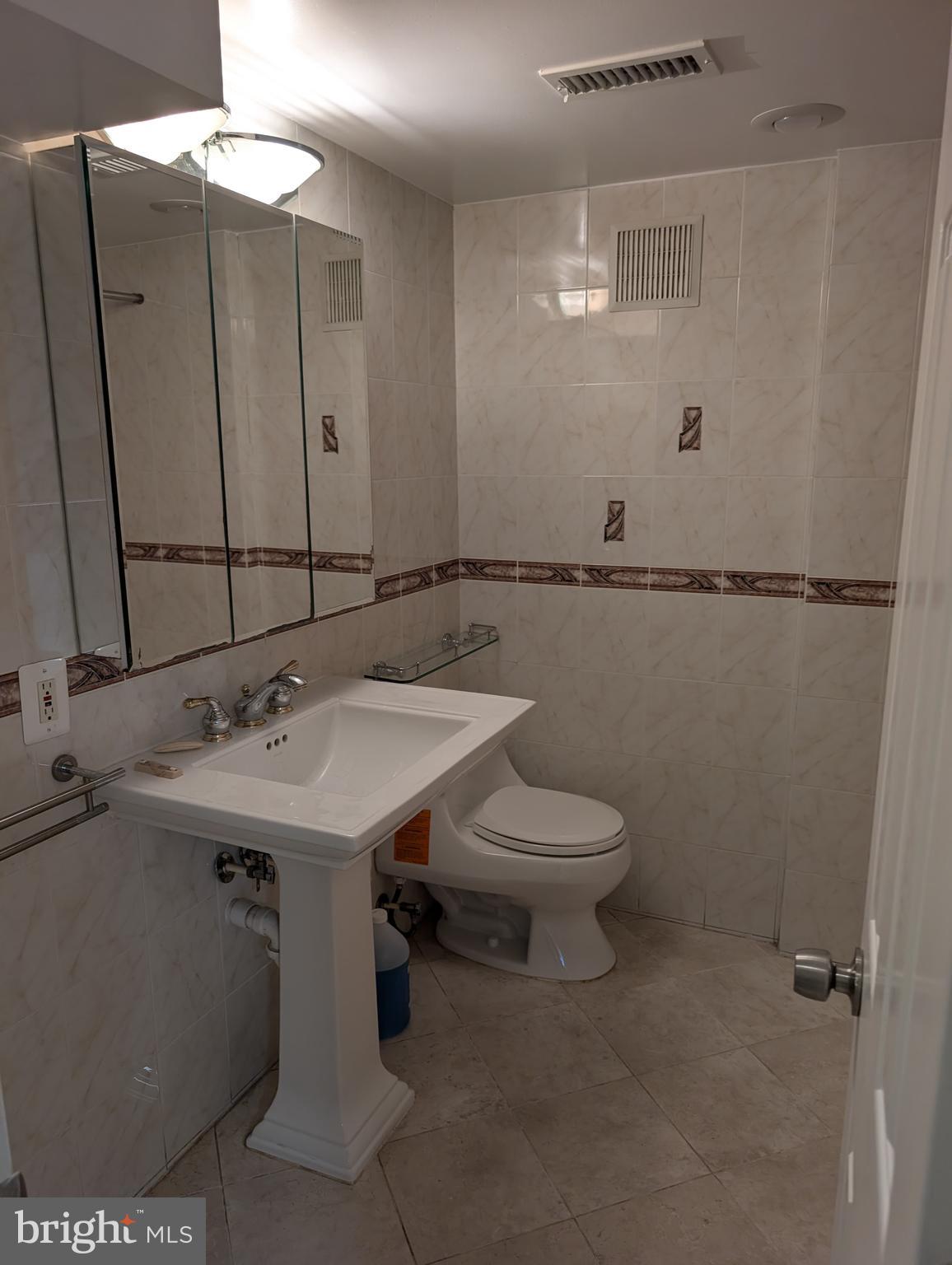 6705 Goldsboro Road Bethesda, MD 20817 - Photo 17 of 60 a bathroom with a sink and mirror